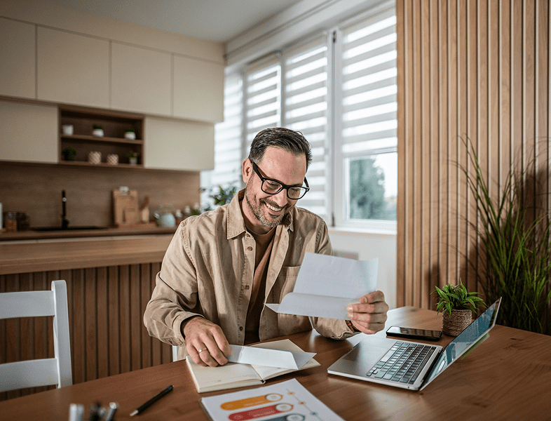 Man reading a letter at home office