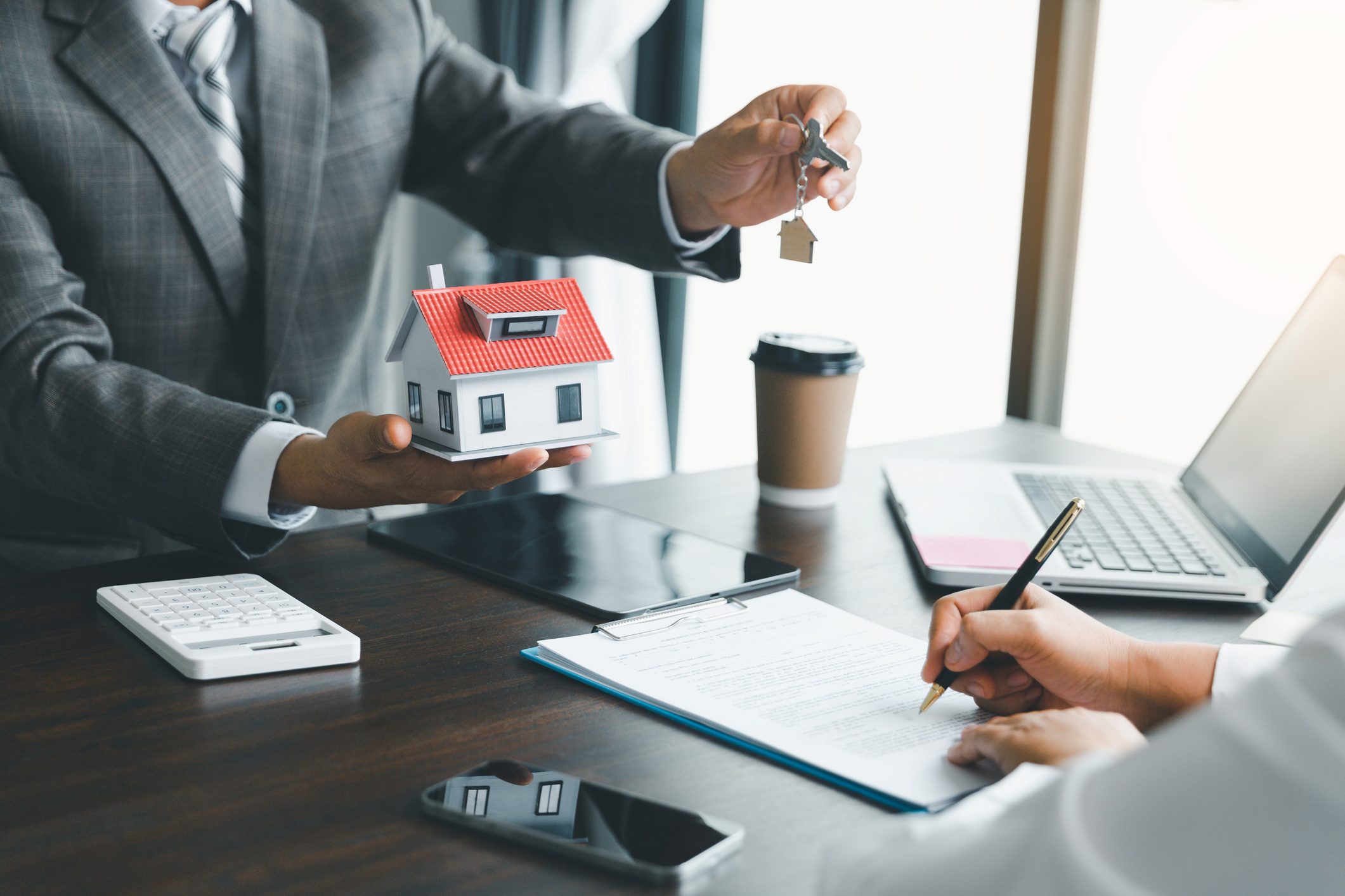 Signing real estate contract at meeting